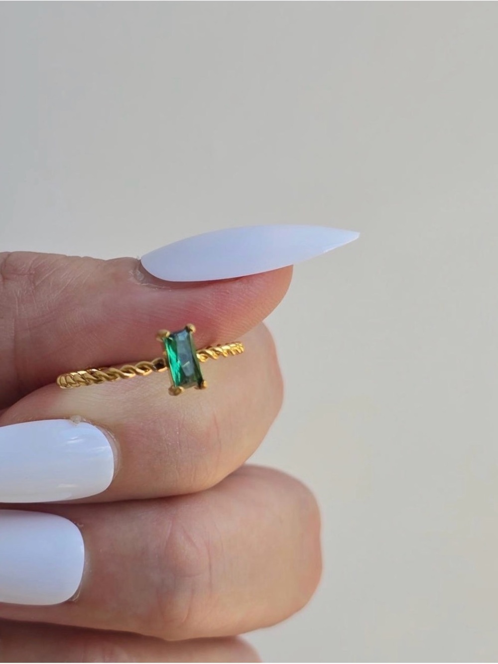 Gold Twist Band Ring with Emerald Green Baguette Stone